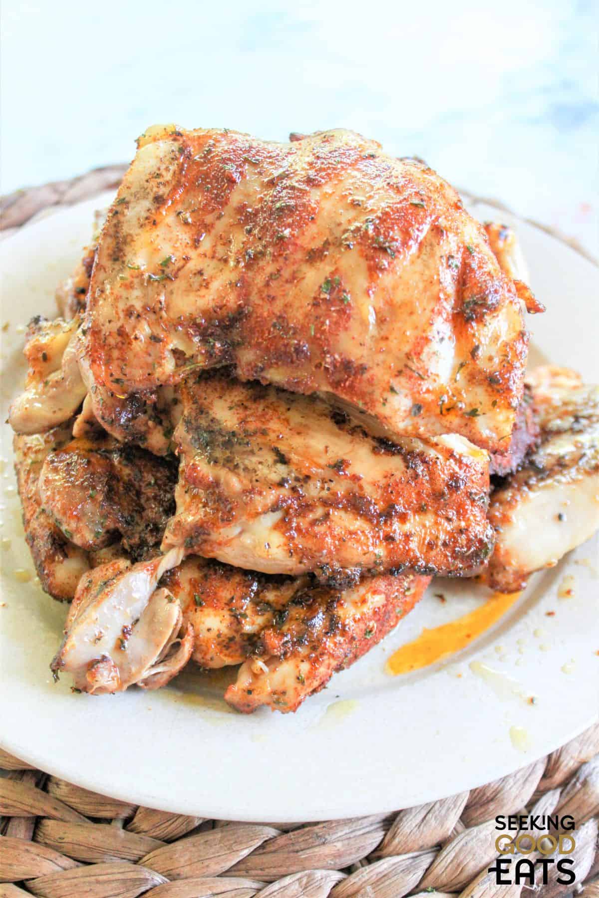 A plate of juicy boneless grilled chicken thighs. 