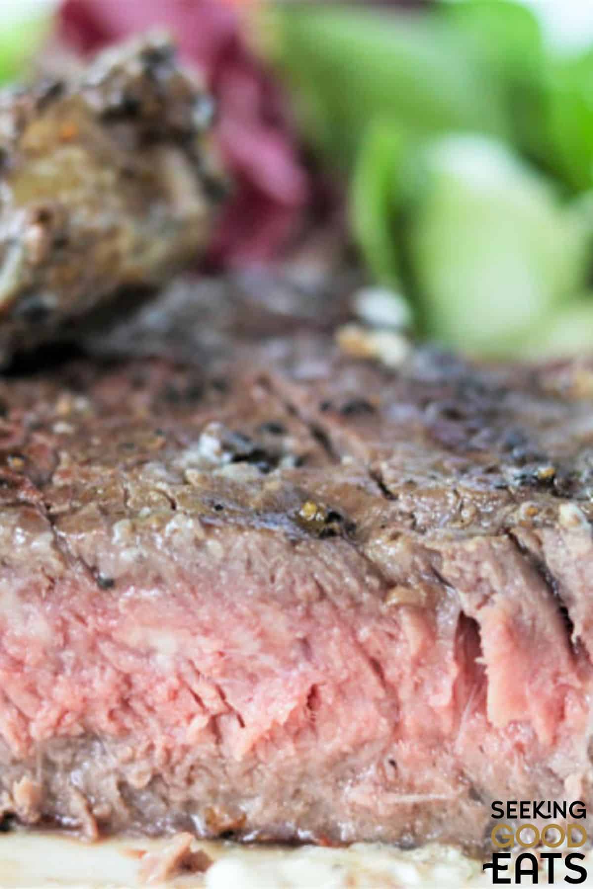 Piece of grilled steak cute in half.