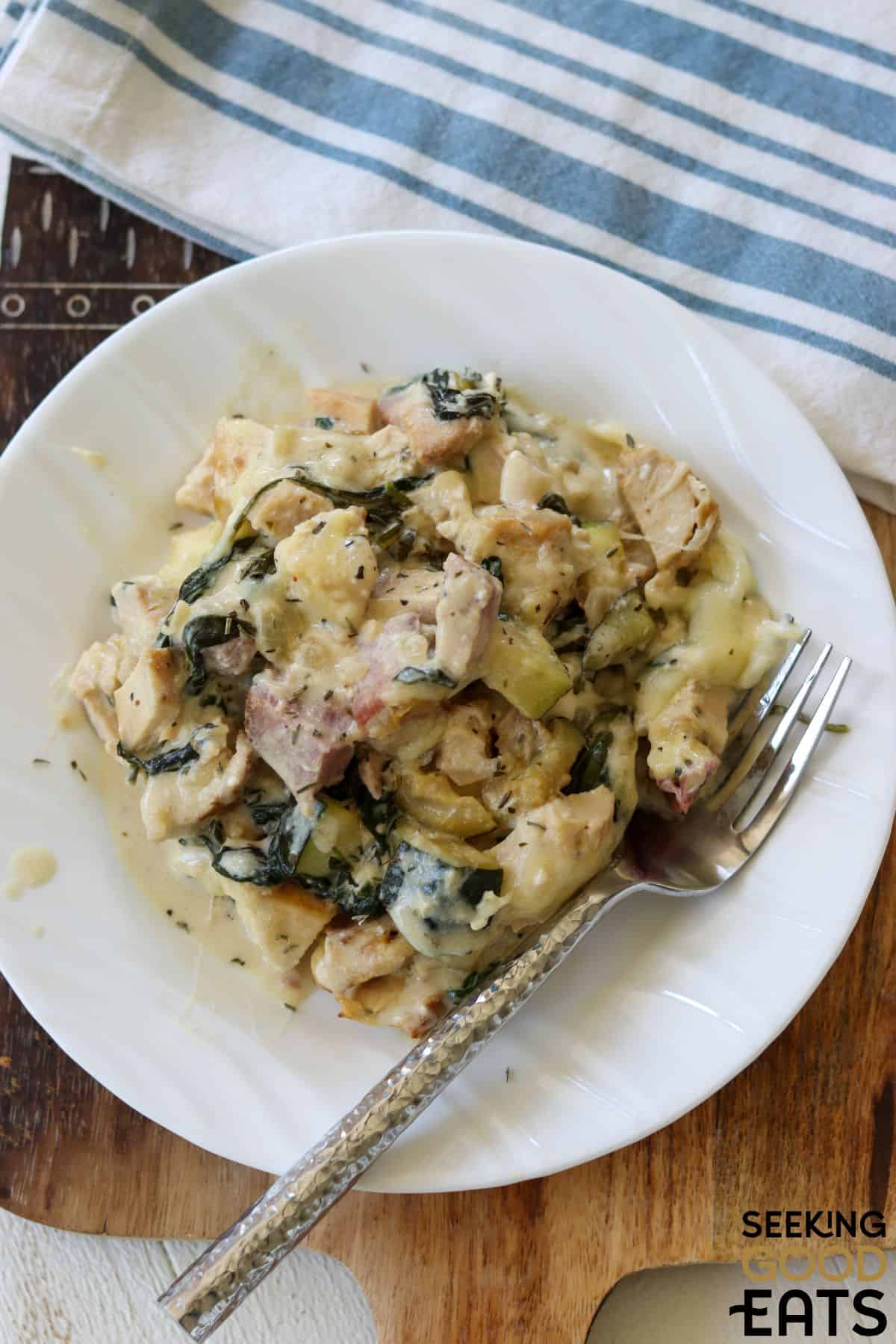 Plate of healthy chicken cordon bleu casserole served on a plate with a fork.