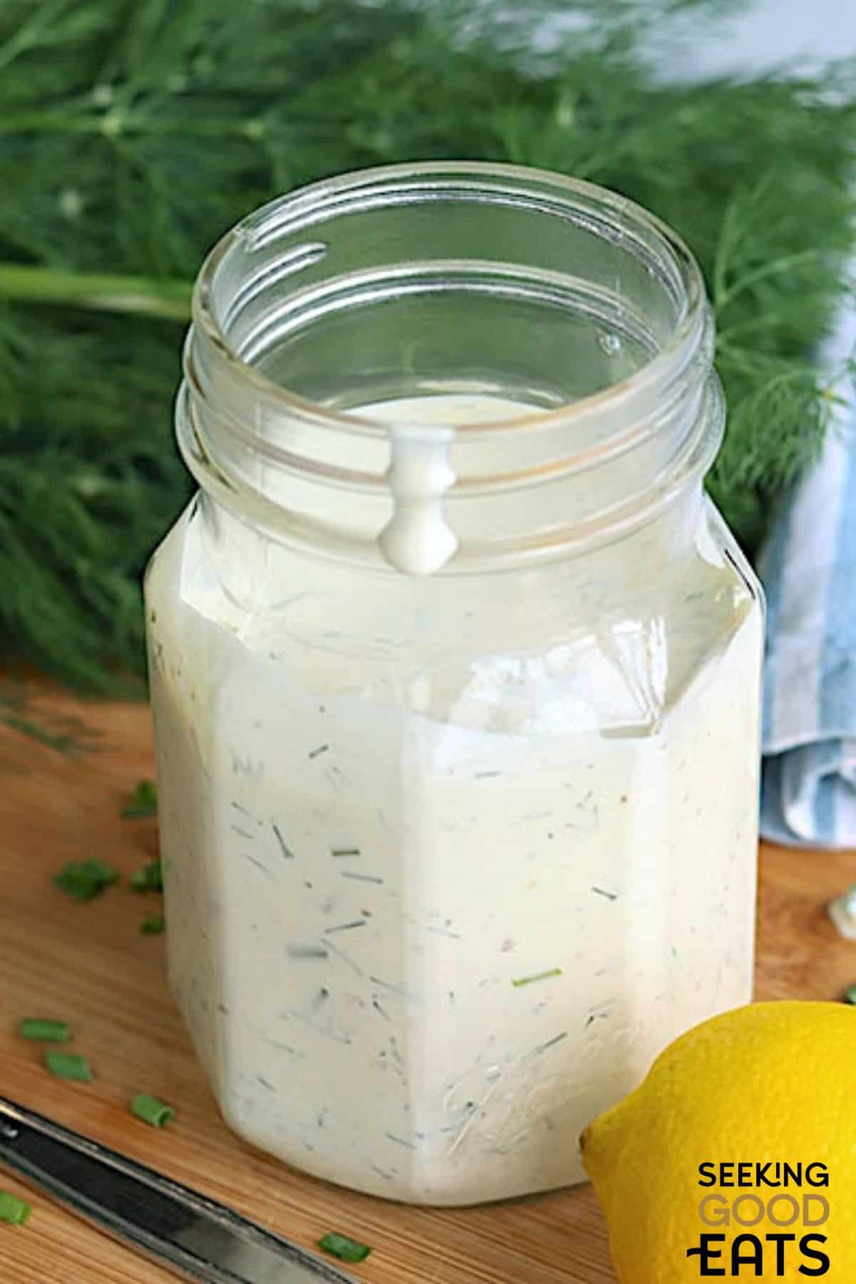 Creamy homemade dill dressing in jar.