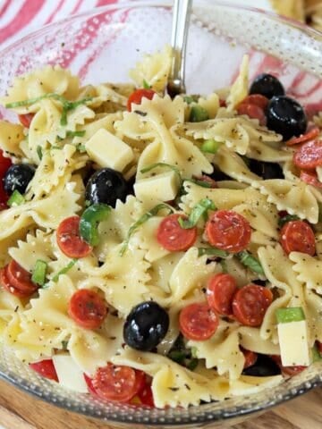 Square feature top down image of italian salad served in a clear bowl