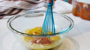 Mixing wet ingredients in a clear glass bowl