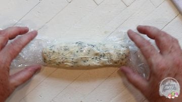 Rolling up butter into a log shape.