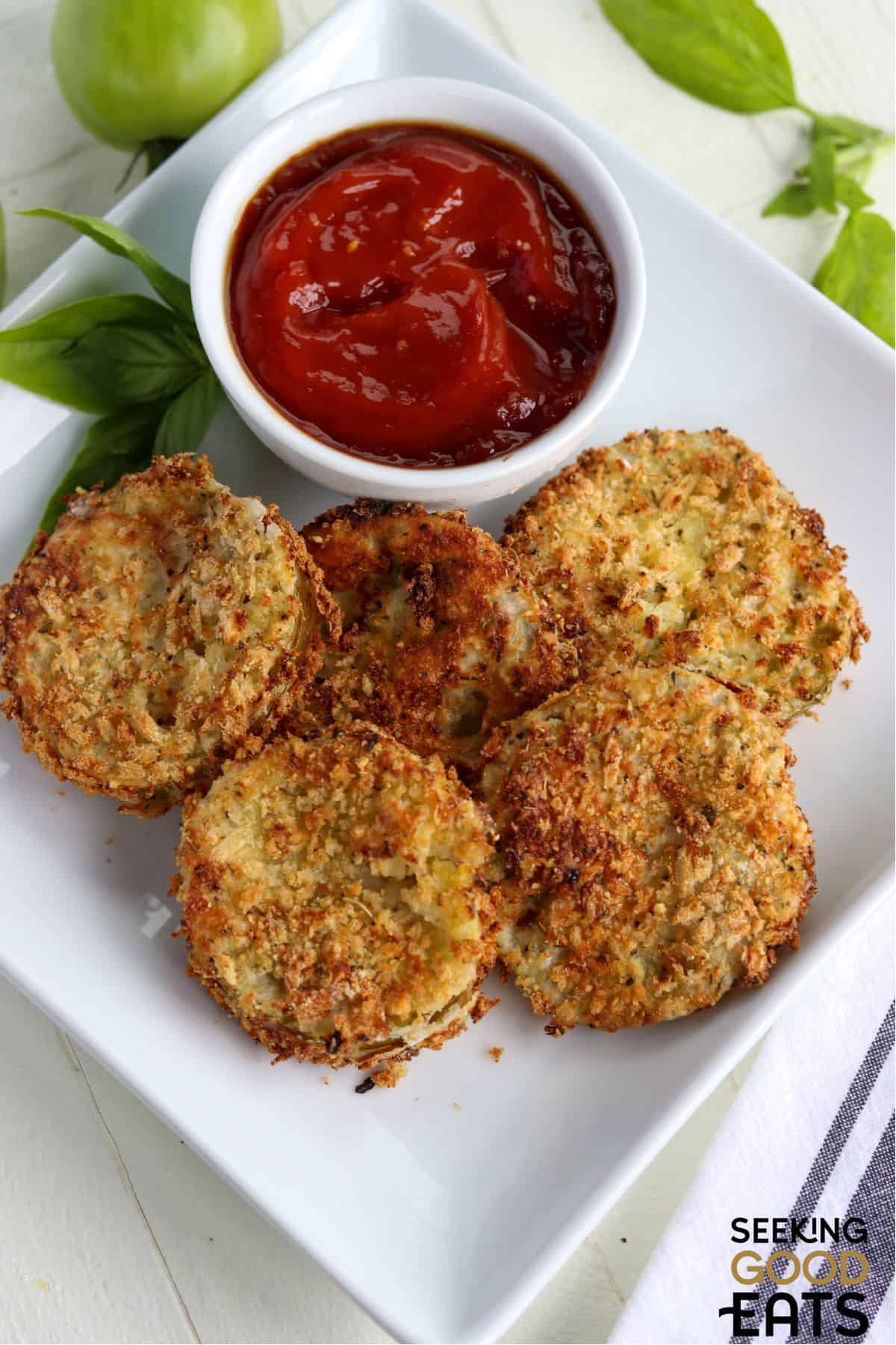 Air fryer fried green tomatoes sliced and served with a dipping sauce.