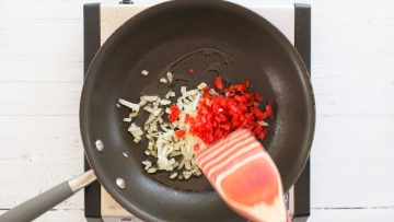 sauteeing vegetables in a pan for turkey burgers