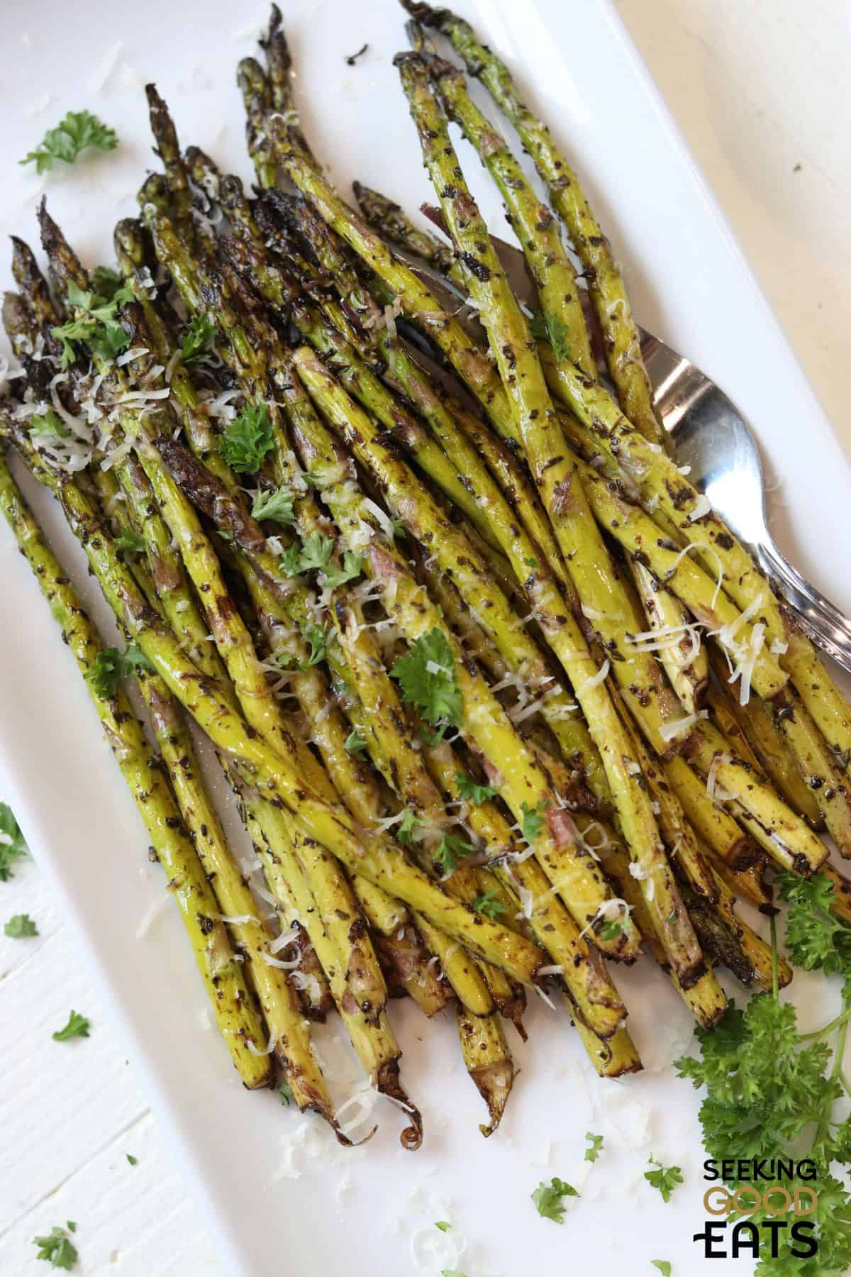 Air fryer asparagus topped with parmesan cheese. 