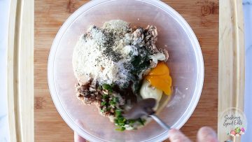 mixing the salmon patty ingredients in a clear bowl