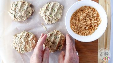 shaping the salmon patties on a wooden board and parchment paper