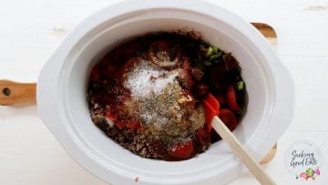 Adding the remaining chili ingredients to the slow cooker