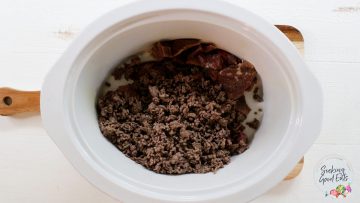 Adding cooked ground beef to the slow cooker