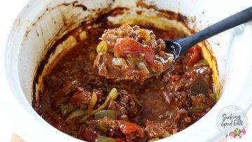 Serving a spoon full of chili out of the slow cooker