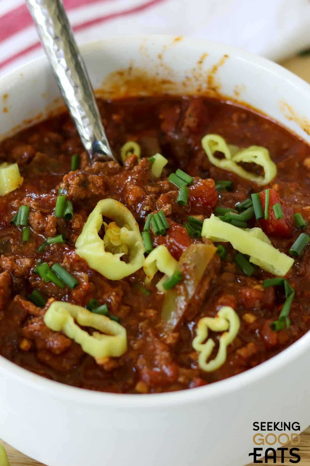 Bowl of crockpot Texas chili with spoon.