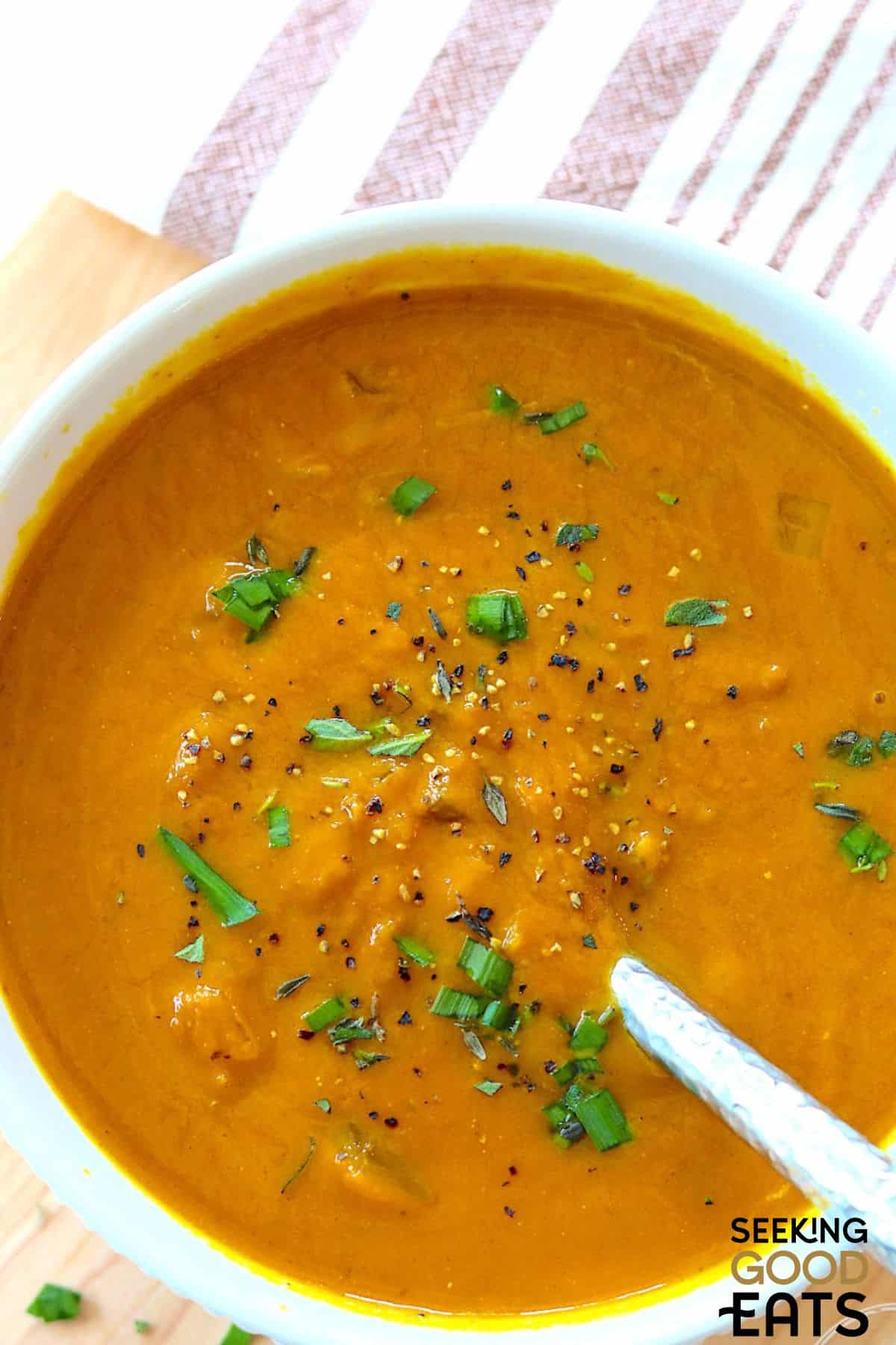 A bowl of creamy pumpkin soup in the slow cooker served in a bowl.