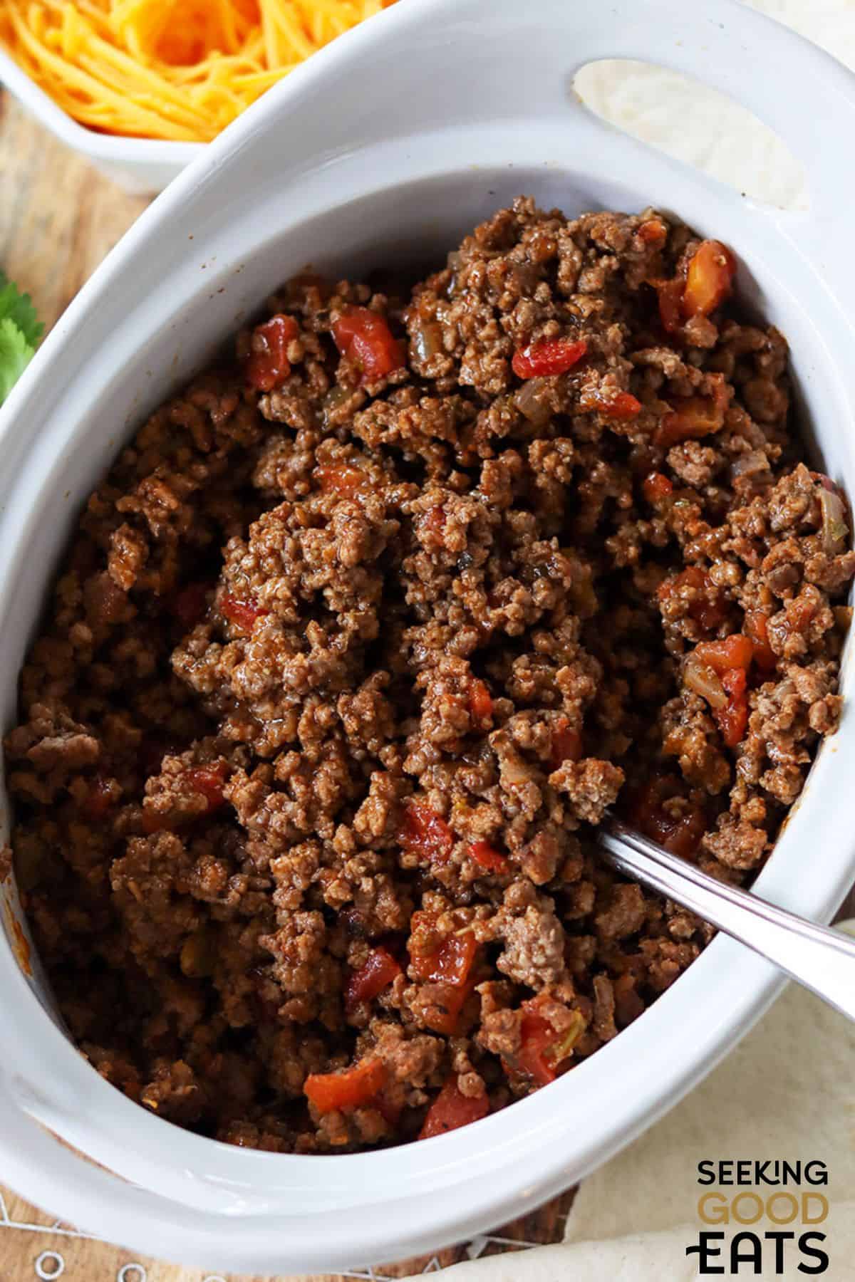 Bowl of Mexican ground beef with spoon.
