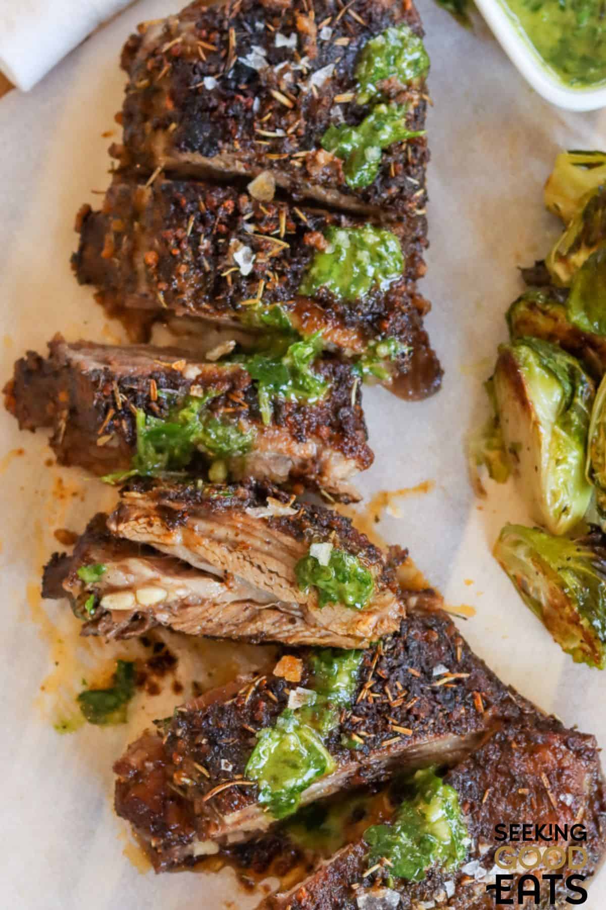 Oven roasted breast of lamb sliced on a plate.