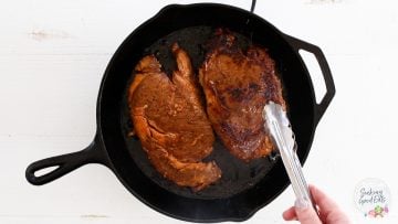 searing the ribeye seaks in a cast iron skillet