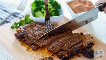 slicing up the searted ribeyes on a cutting board