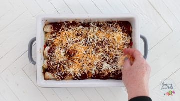 Assembling the casserole and sprinkling cheese on top