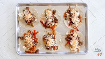 Filling the carne enchilada filling in corn tortillas.
