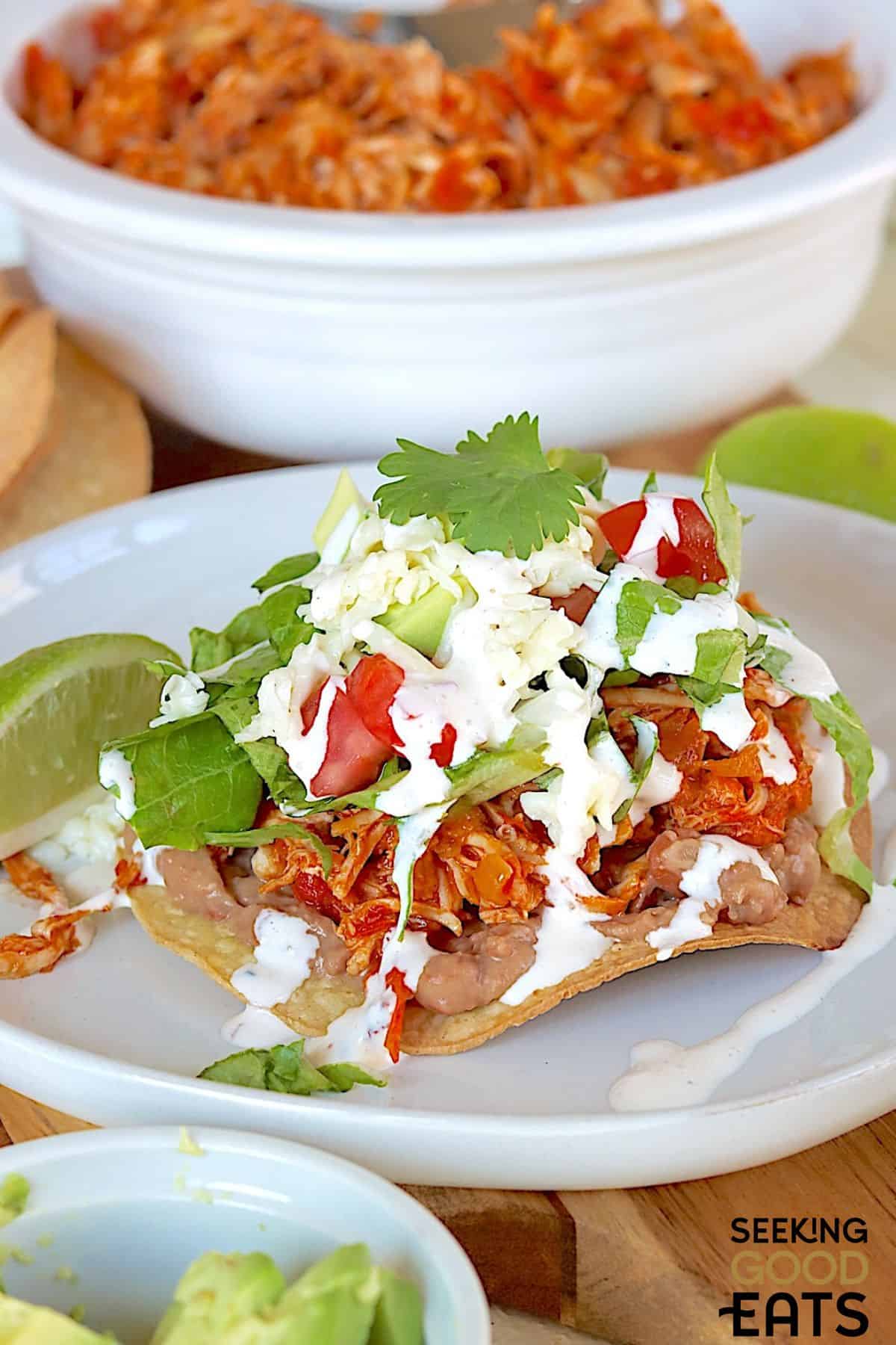 Tinga chicken tostadas served on a plate.