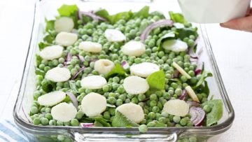 layering lettuce, peas, water chestnuts,, and onions.