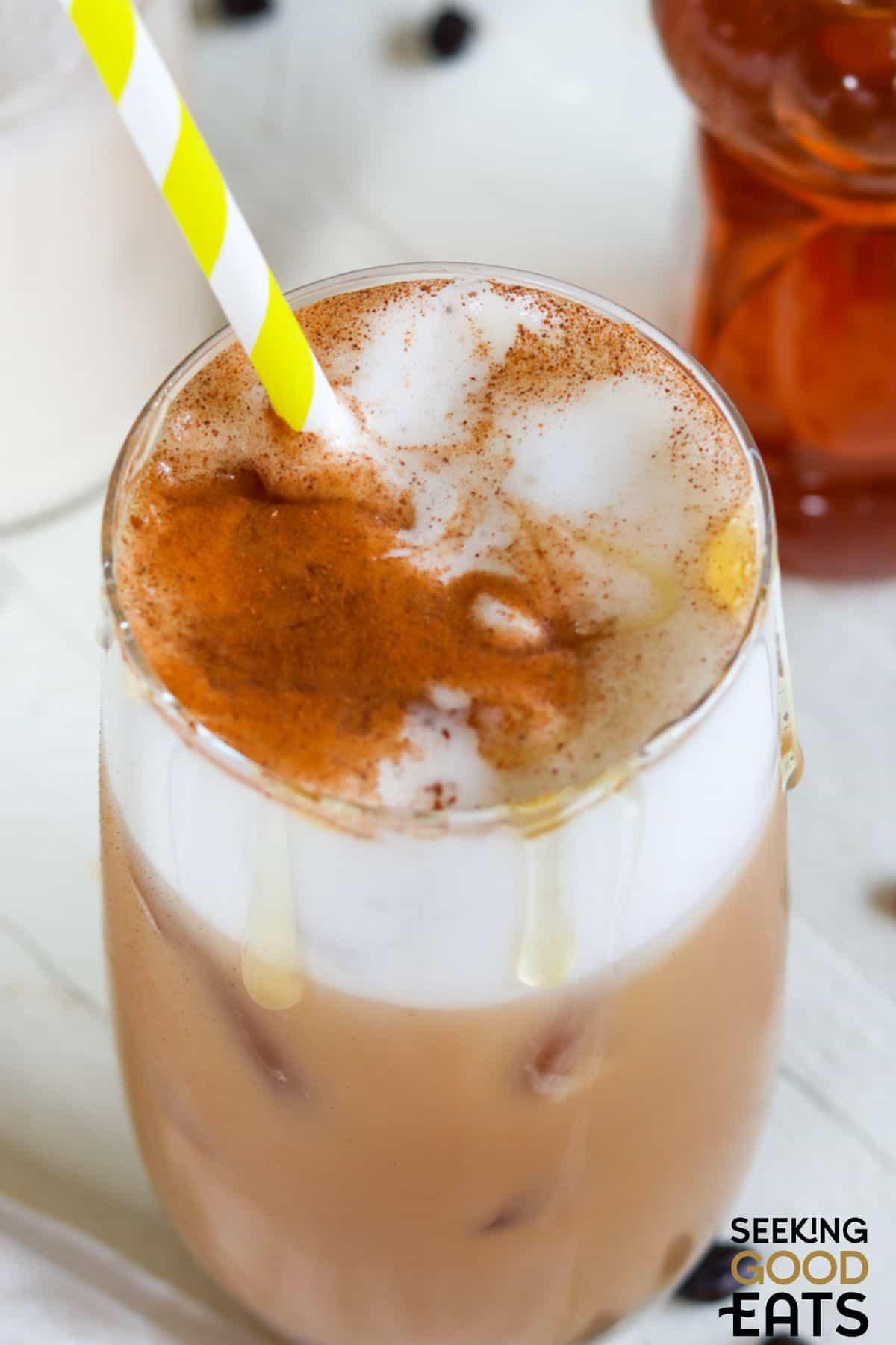 Glass of cold brew almond milk with honey.