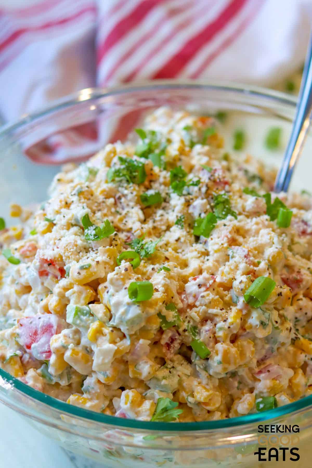 Mexican street corn salad with spoon.
