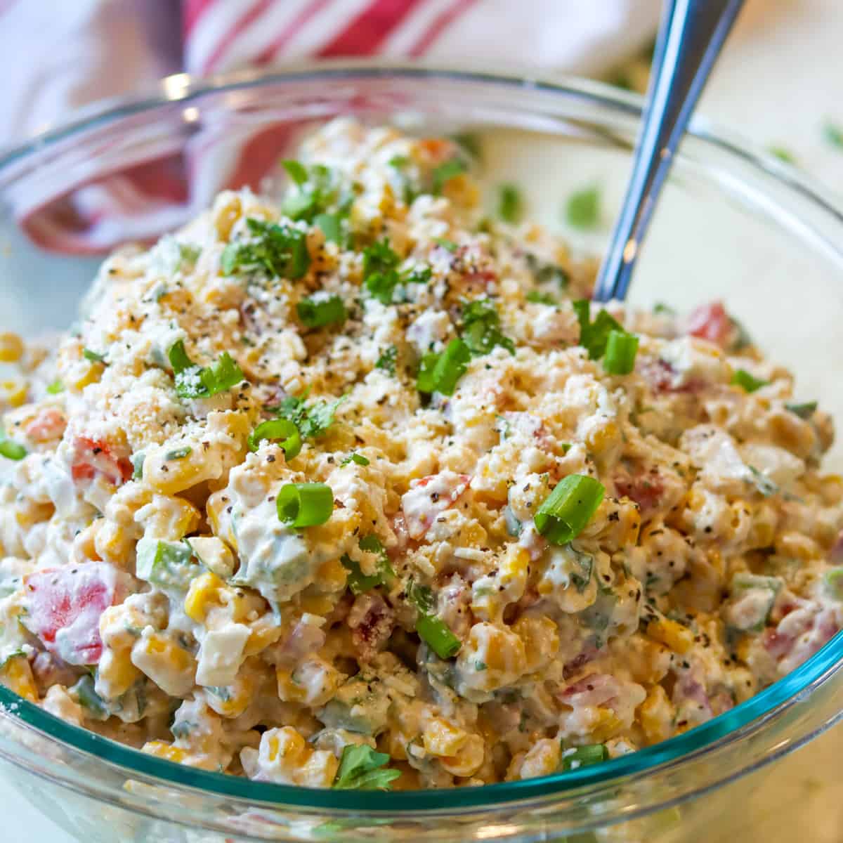Street corn salad served in a clear bowl.