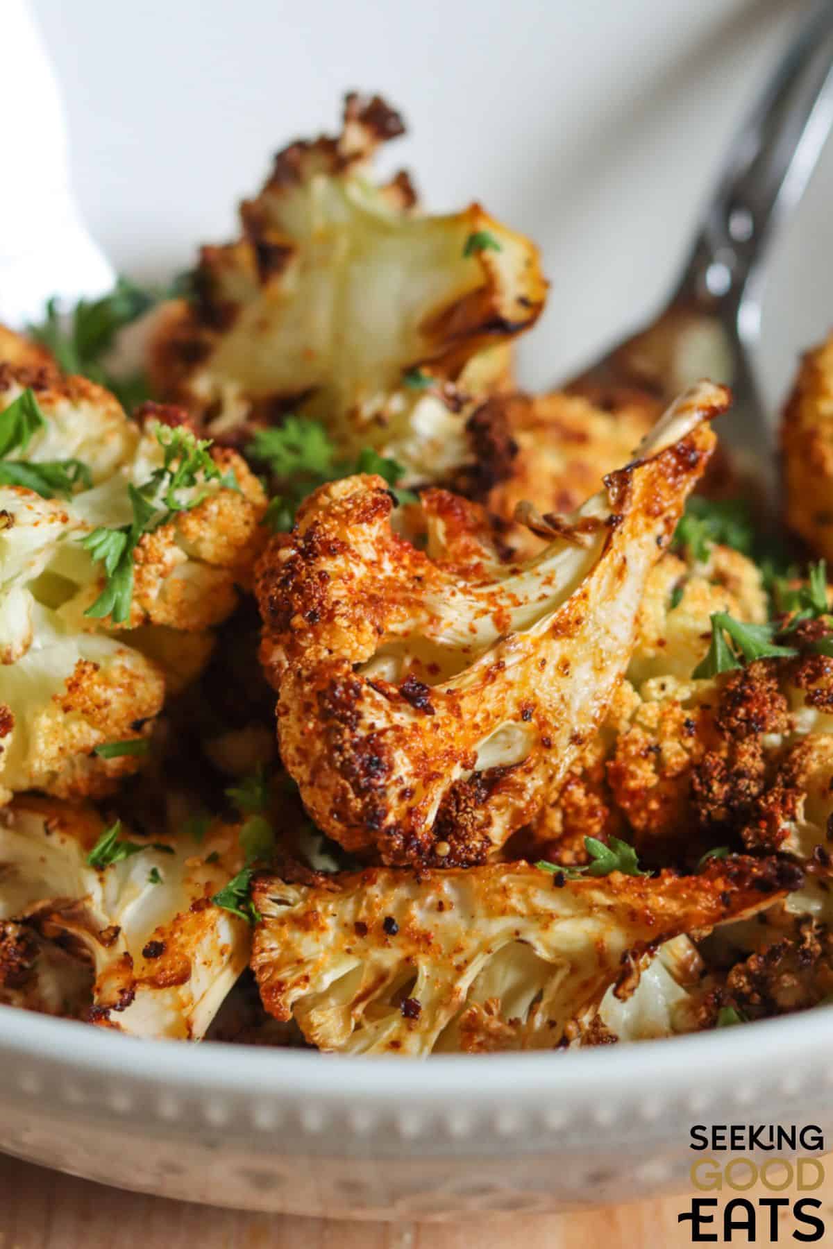 Crispy air fried cauliflower with a fork.