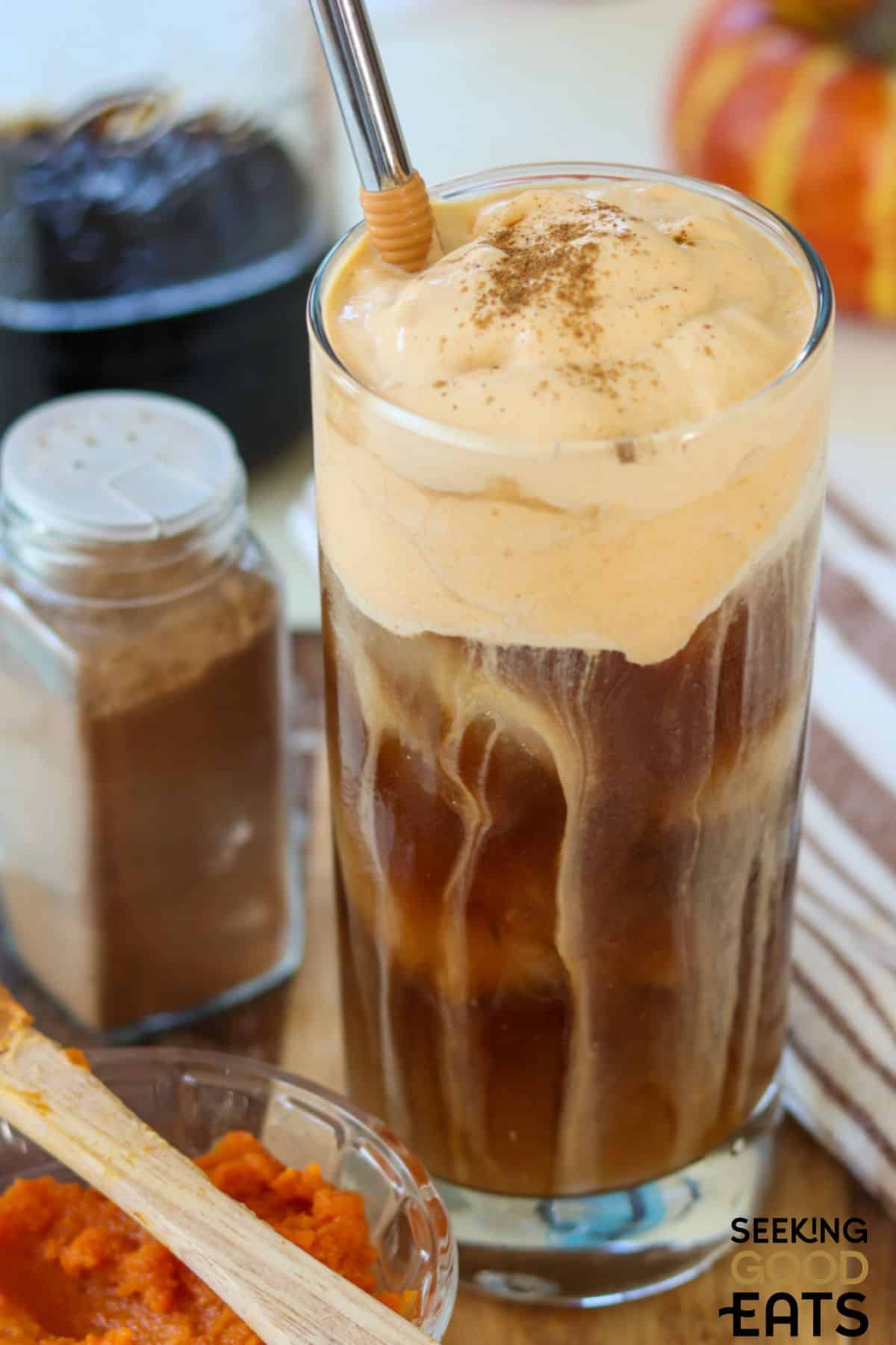 Glass of pumpkin cold brew made at home with a straw.