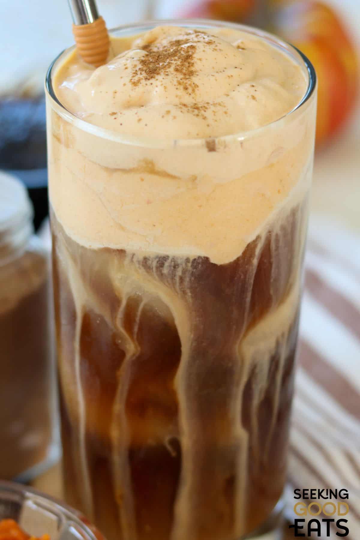 Glass of homemade copycat pumpkin iced coffee with a straw.