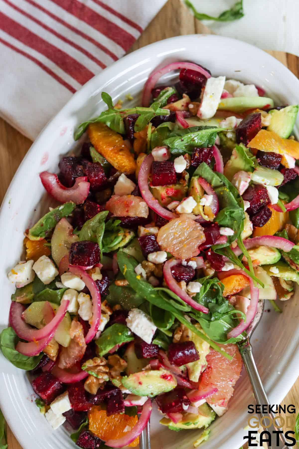 Roasted beet salad recipe with feta cheese served on a white plate.