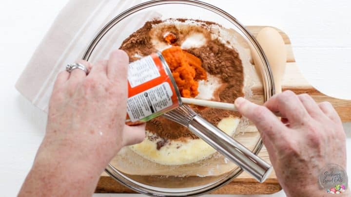 Adding pumpkin puree to the pie filling.