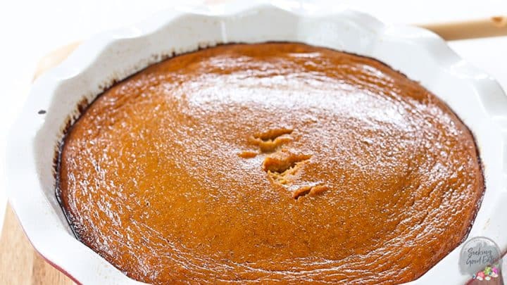 A just baked pumpkin pie in a white pie dish.