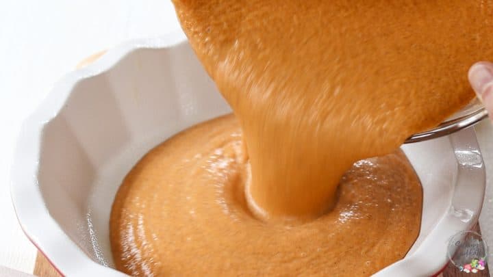 Pouring the pumpkin pie filling into the pie dish