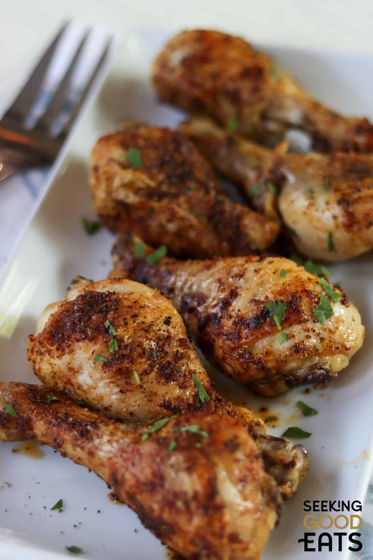 easy baked chicken legs served on a white plate