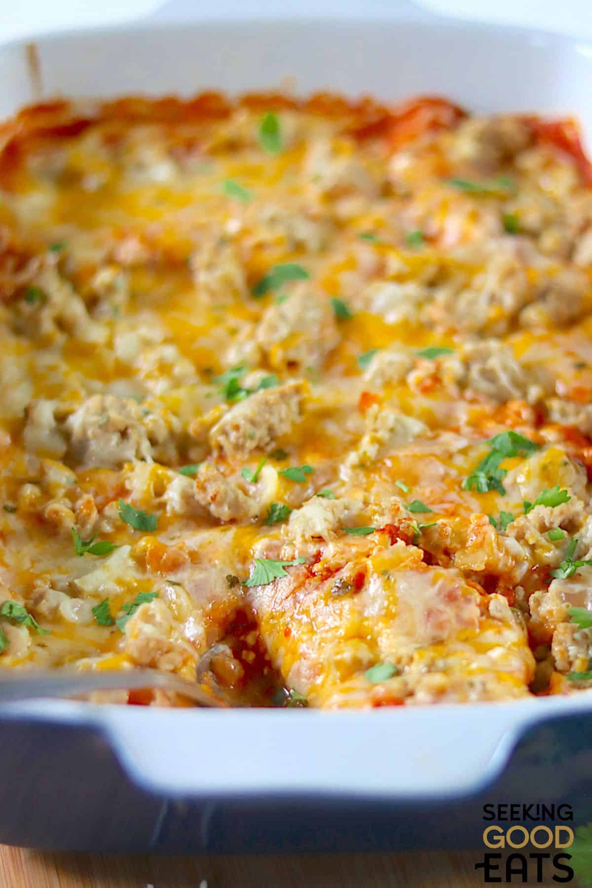Close-up of baked chicken enchilada casserole.