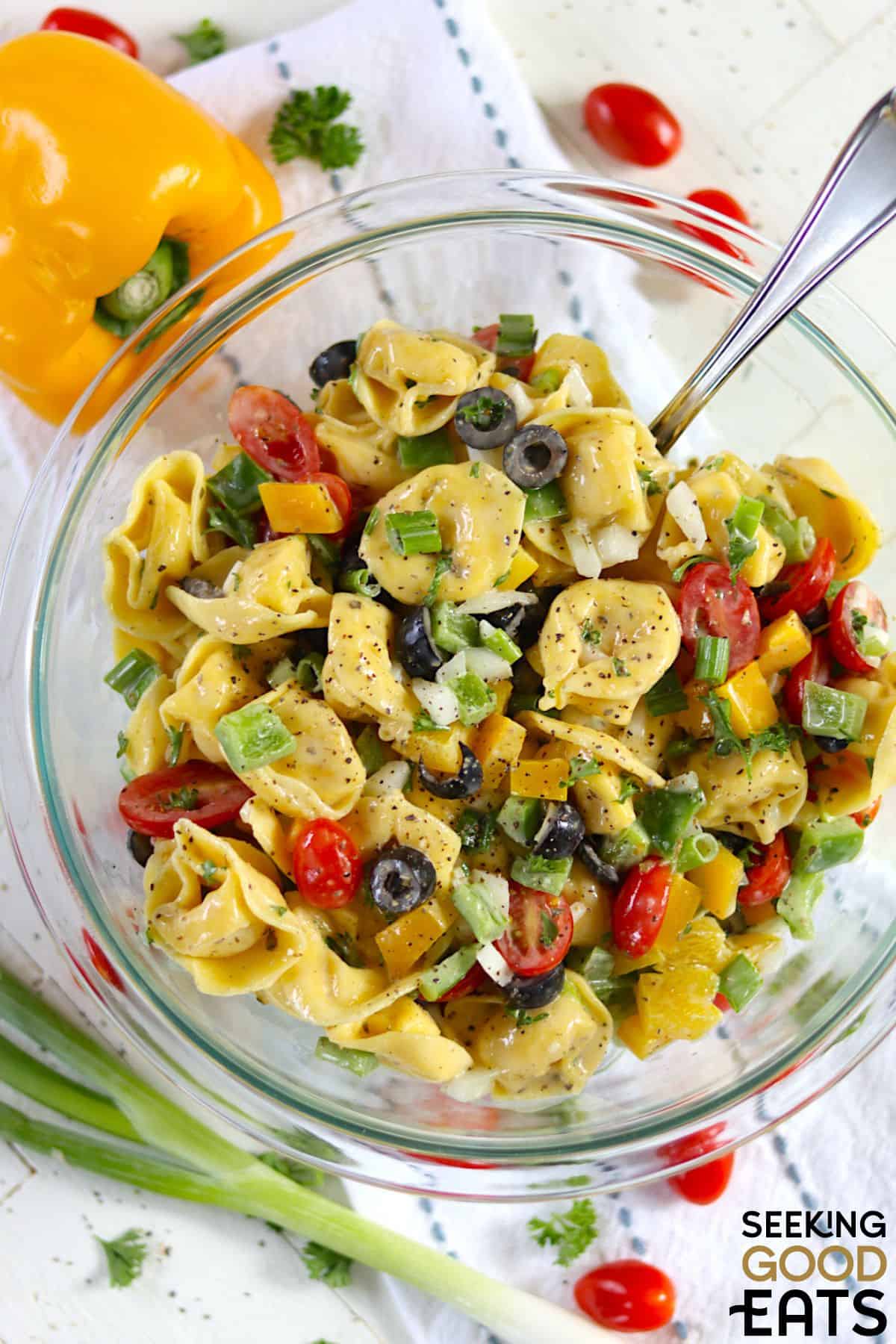 Cheese tortellini pasta salad with fresh veggies and a tangy dressing.
