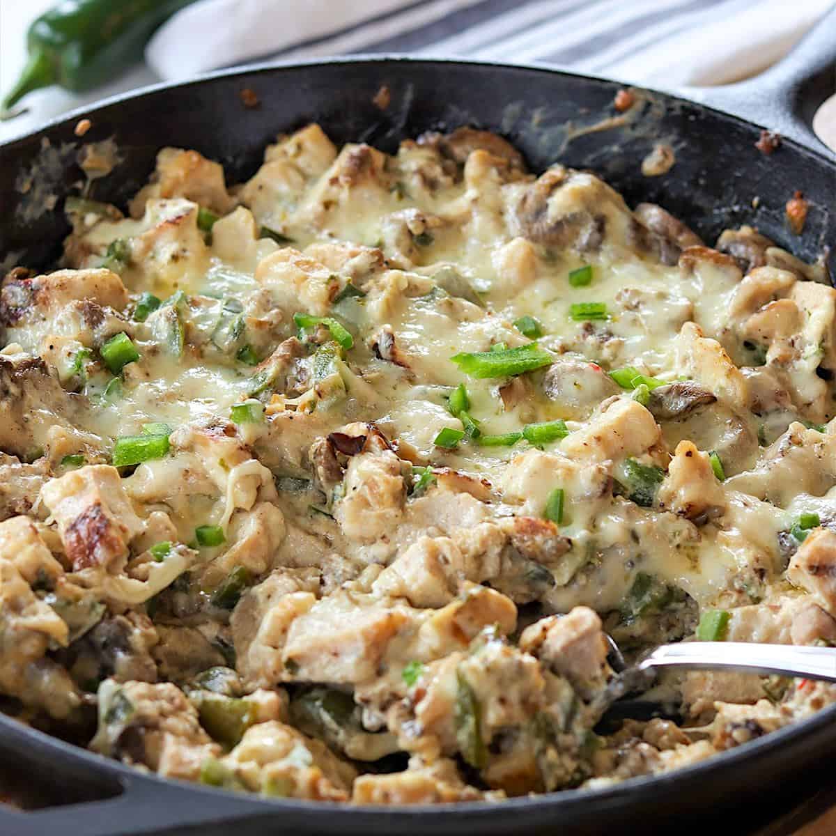 A cast iron skillet baked with chicken jalapeno pepper casserole.