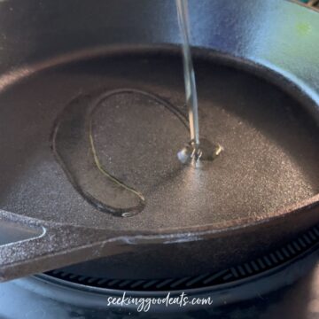 Adding oil to a cast iron skillet.