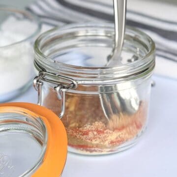 Mixing homemade fajita seasoning mix in a jar.