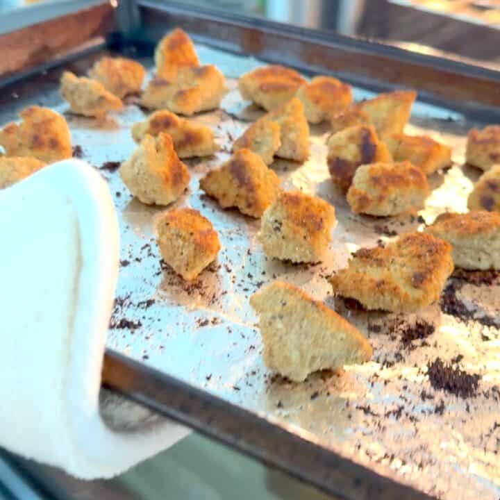 Removing the buffalo tofu wings from the oven.