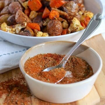 A white bowl with a spoonful of homemade vegetable seasoning mix.