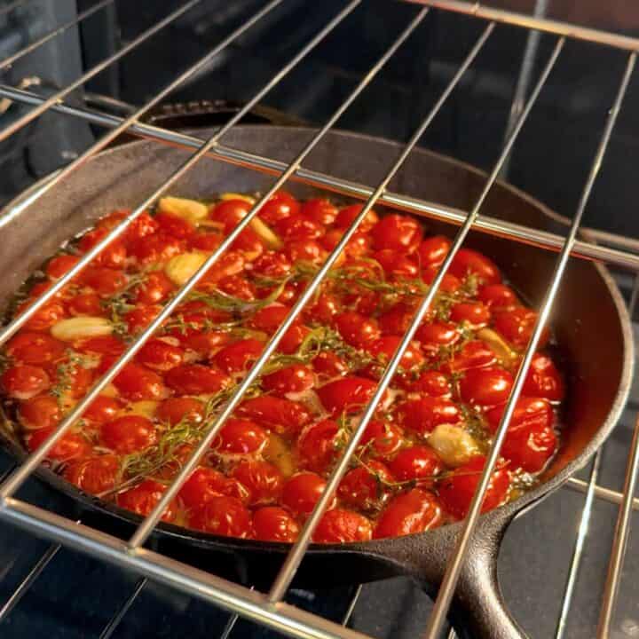 Slow-roasting the tomatoes, oil, and herbs in the oven.