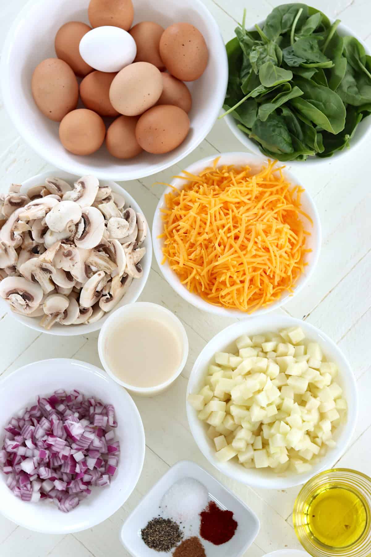 Ingredients needed for making a savory apple cheddar frittata recipe.