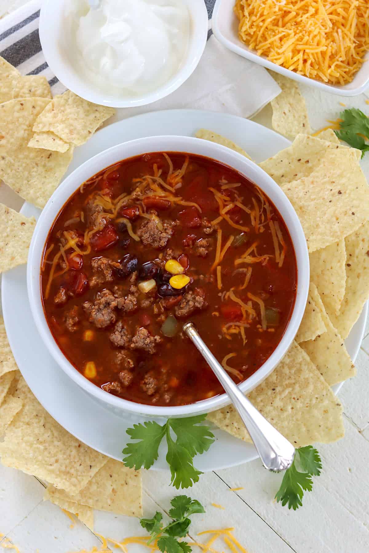 A white bowl of beef enchilada soup.
