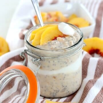 Layered peach overnight oats with vanilla yogurt and fresh sliced peaches.