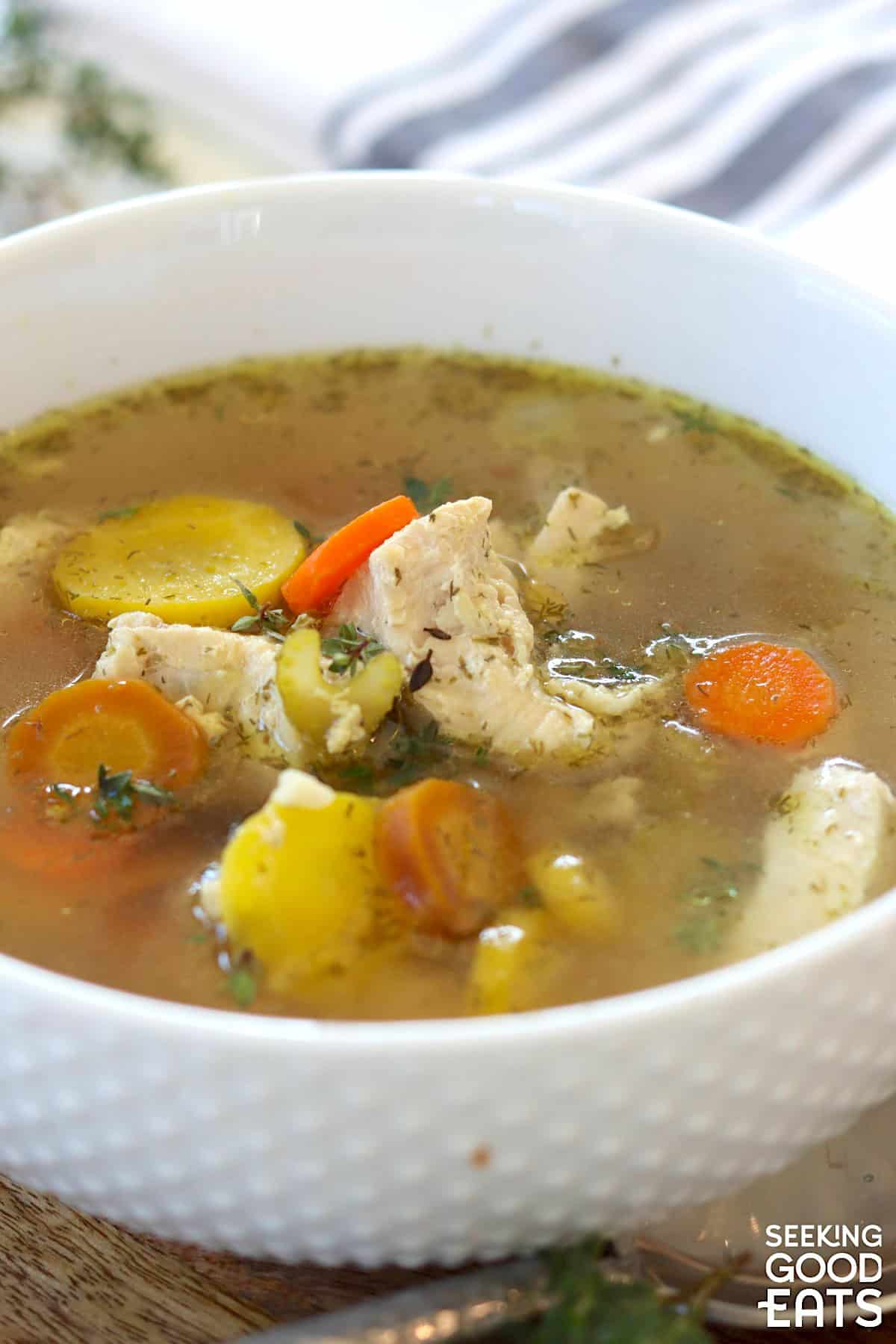 Low carb chicken soup pressure cooker recipe served in a white knobby bowl.