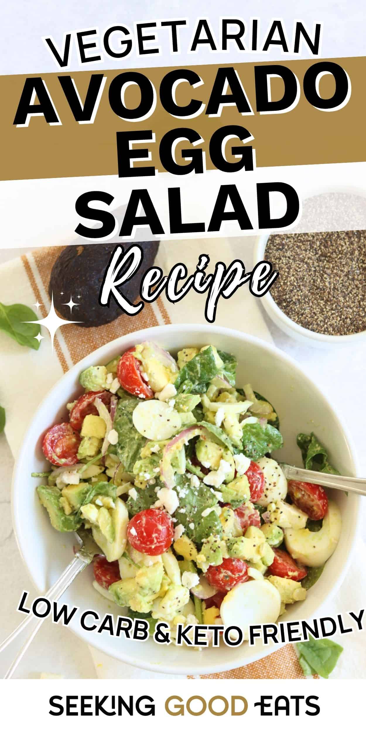Bowl of avocado egg salad with cherry tomatoes, spinach, and feta, served as a healthy low-carb vegetarian dish.