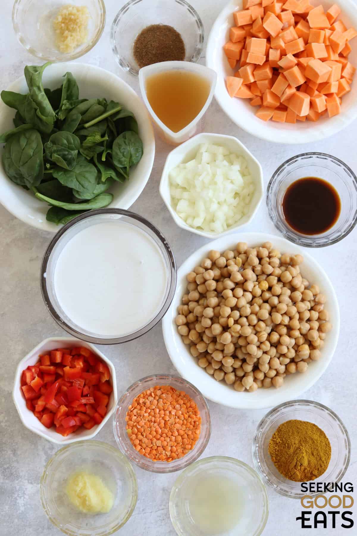 Ingredients needed for making chickpea curry on a white board.